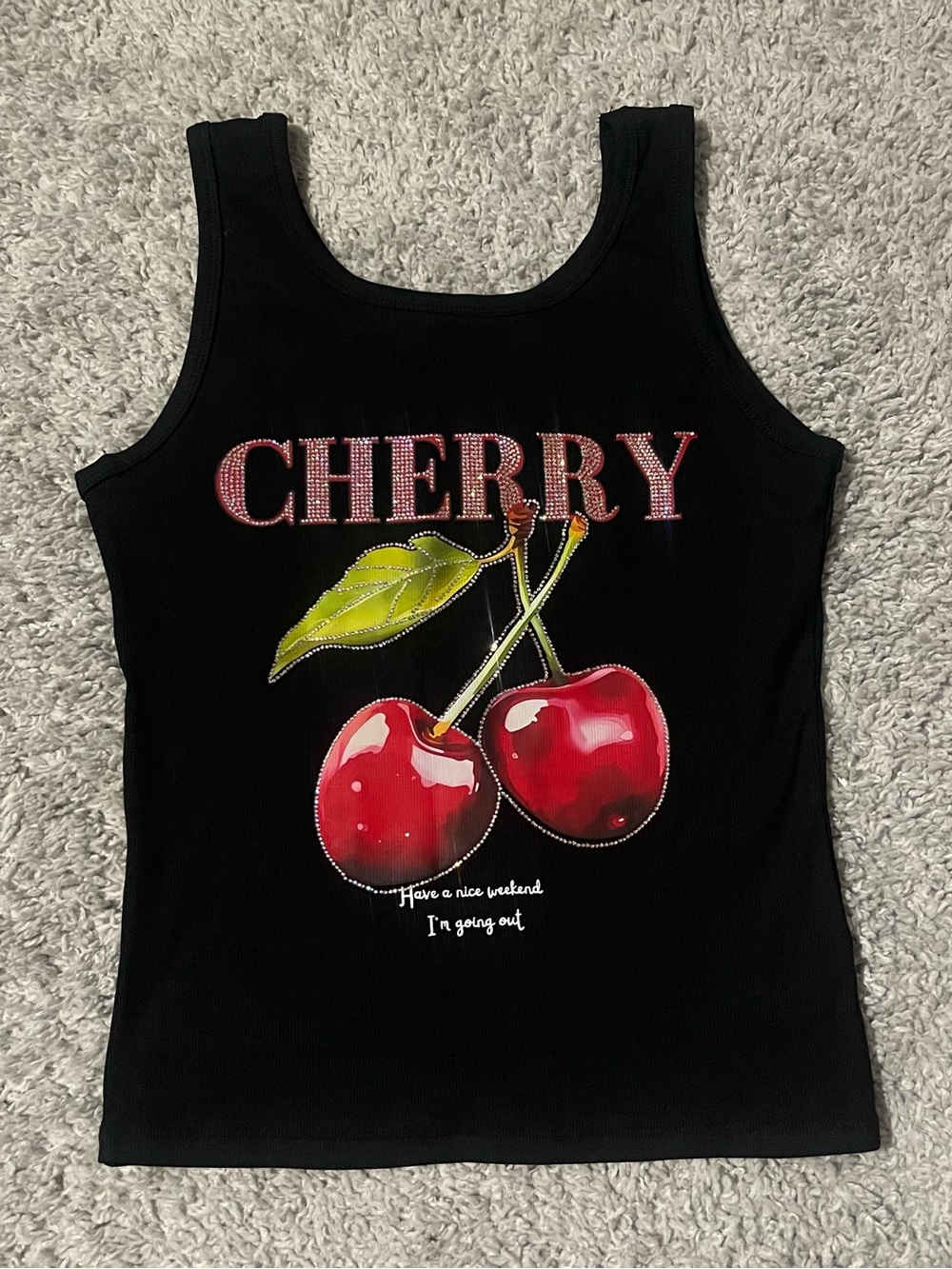 Black tank top with a cute cherry rhinestone design.